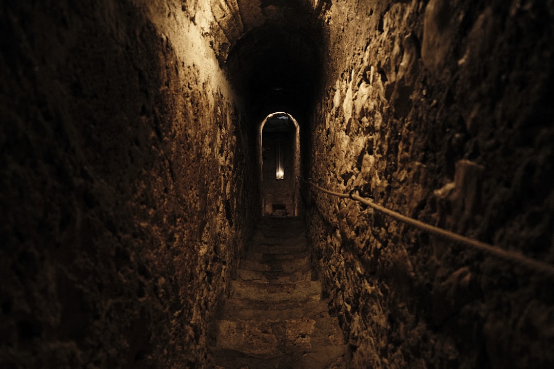 a narrow tunnel with a light at the end